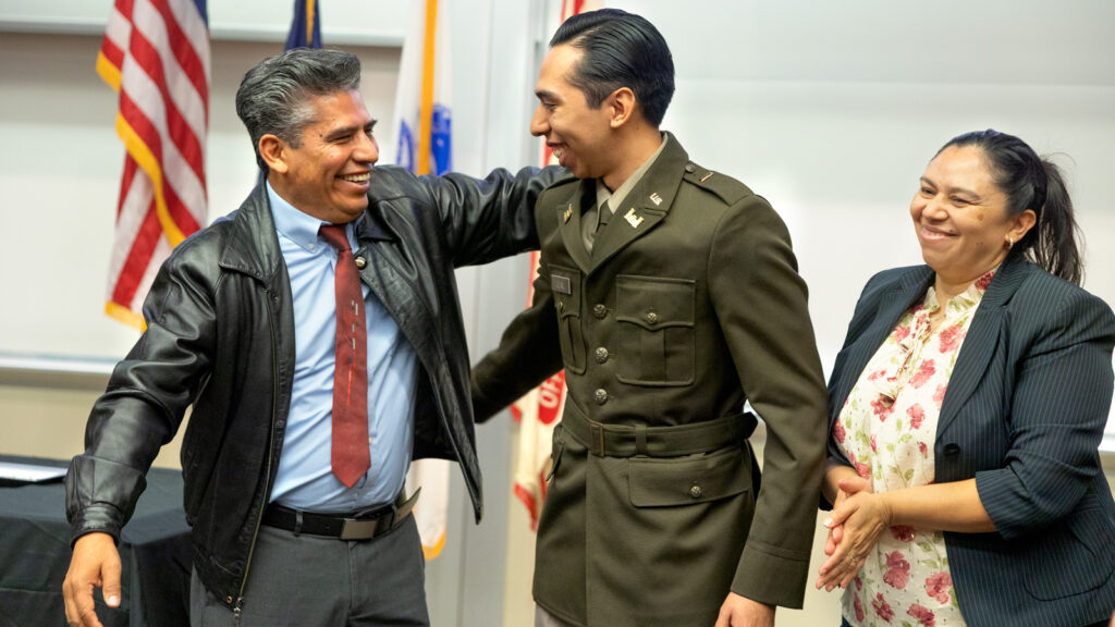 Parents congratulate a young man in an Army uniform