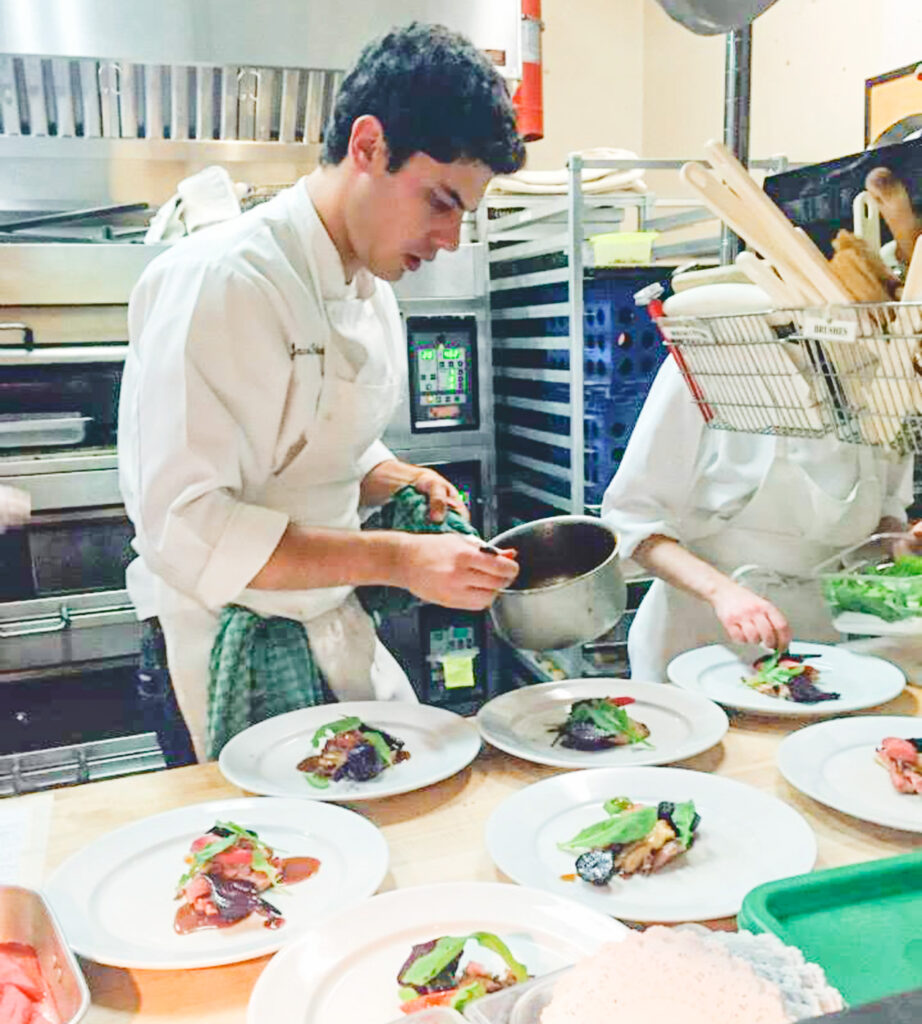 Jake Potashnick plating dishes at the Carriage House Cafe.
