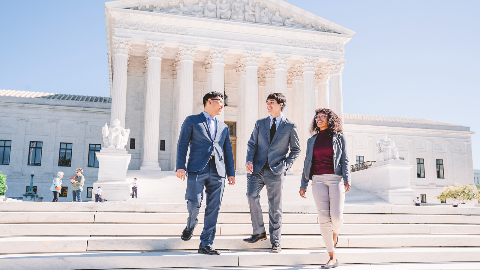 Three students in the Cornell in Washington DC Start program walk down the steps in front of the U.S. Supreme Court Building in fall 2025