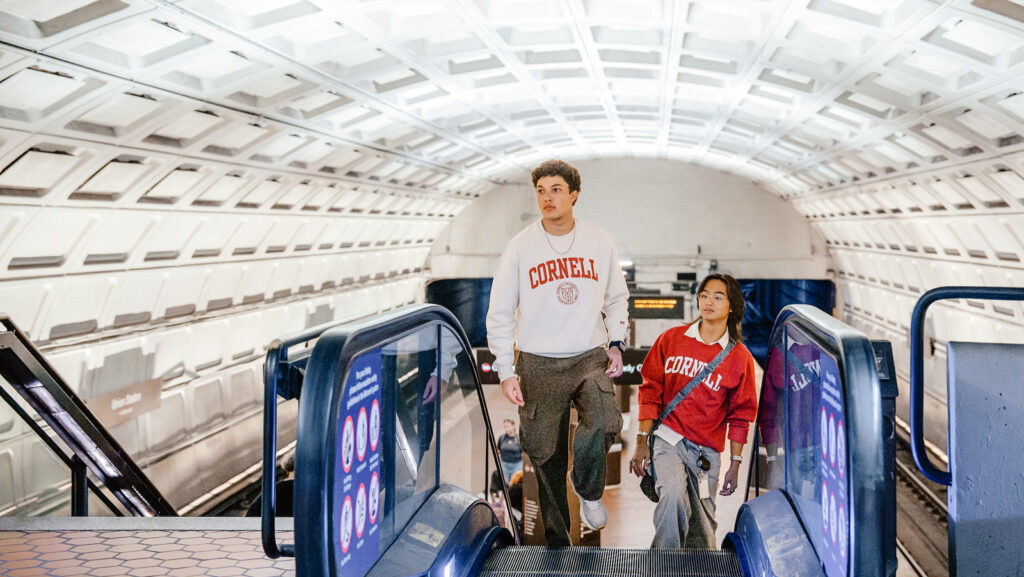 Two students in the Cornell in Washington DC Start program exit a Metro station escalator in fall 2025