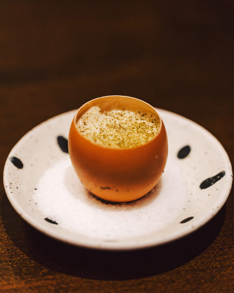 Crab and seaweed egg on a small white and black polka dot plate