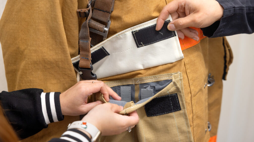 A closeup of a pocket of one of the firefighter suits