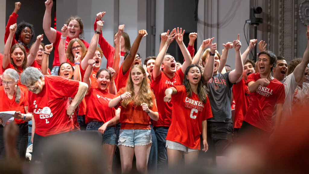 alumni cheer and sing during Cornelliana Night in Bailey Hall at Reunion 2026