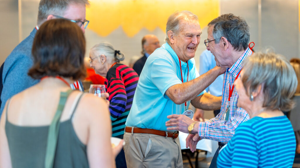 Alumni laugh together during the “Spirit of ’31—Passing It Forward” ceremony in Statler Ballroom