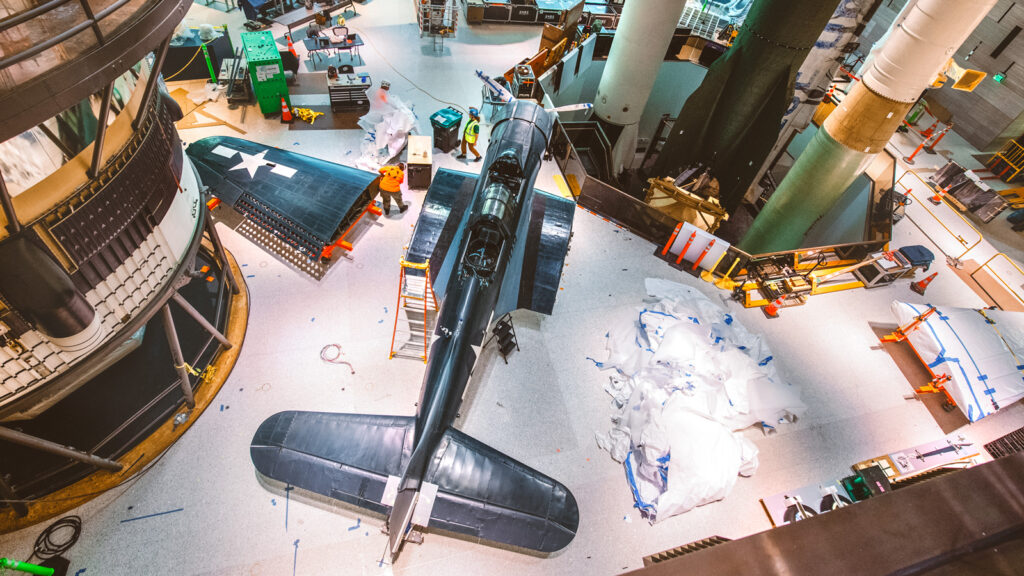 A Douglas SBD-6 Dauntless is assembled in one of the Air and Space Museum galleries under renovation