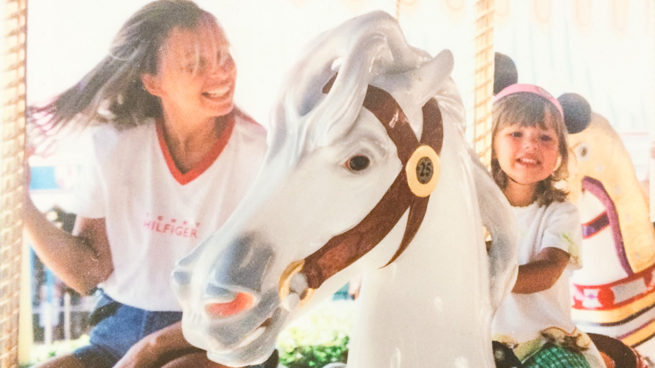 Amanda Friedman and her sister ride a merry-go-round at Disney as kids.