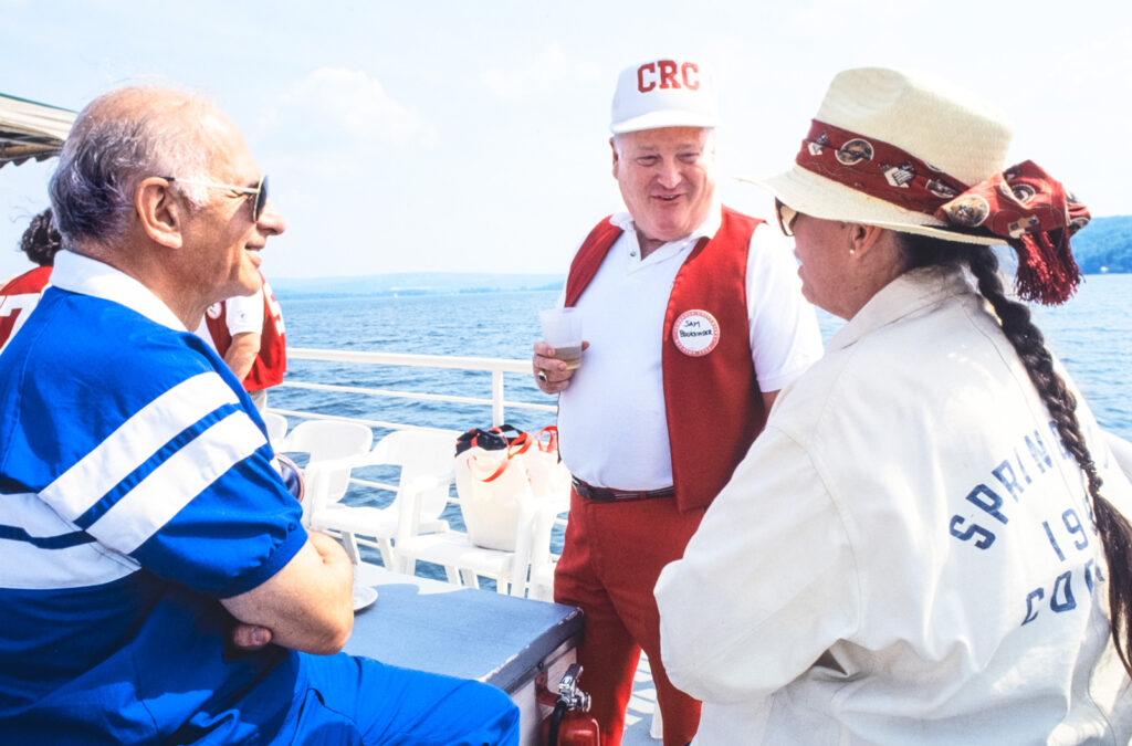 A CRC member chats with fellow alumni at Cayuga Lake during a Reunion gathering in the early 1990s