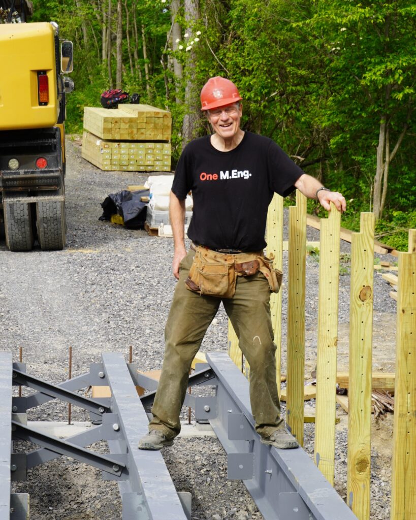  Charlie Trautmann, PhD ’83, stands on a section of bridge under construction