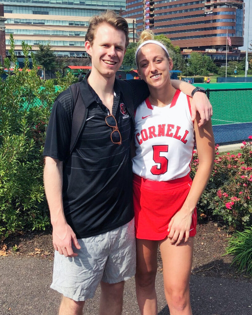 Spencer Kopko and Kristen Ferguson Kopko in her field hockey uniform together after a game.