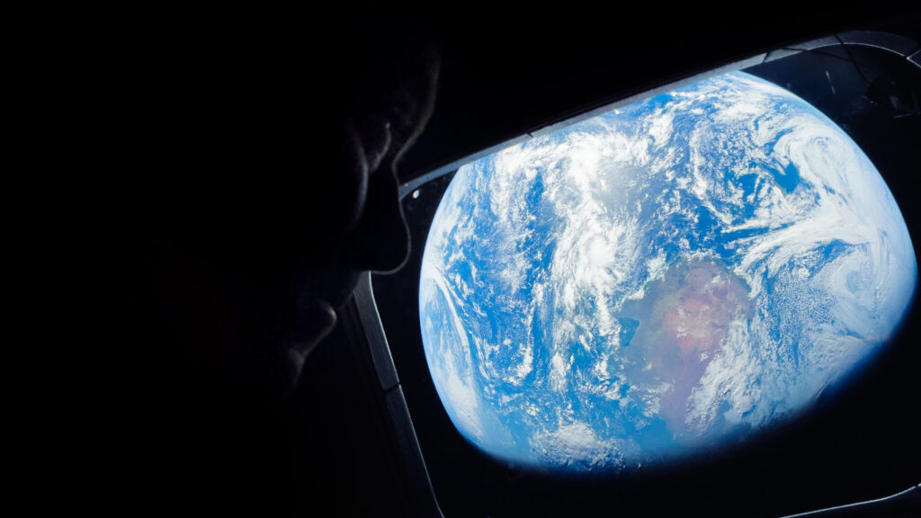 A view of Earth out the window of the Artemis II craft.