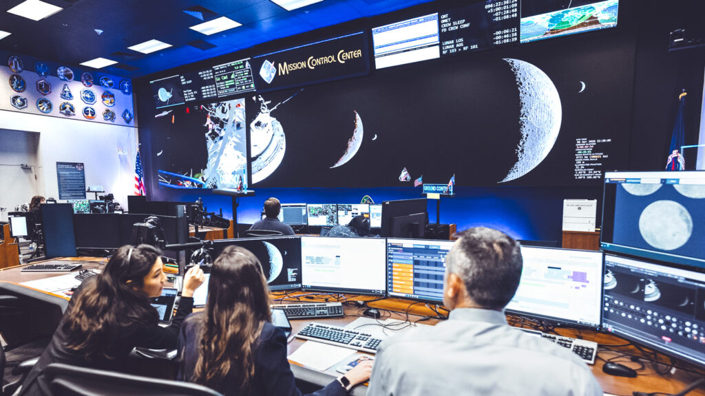 Staff look at screens inside Mission Control during the Artemis II mission