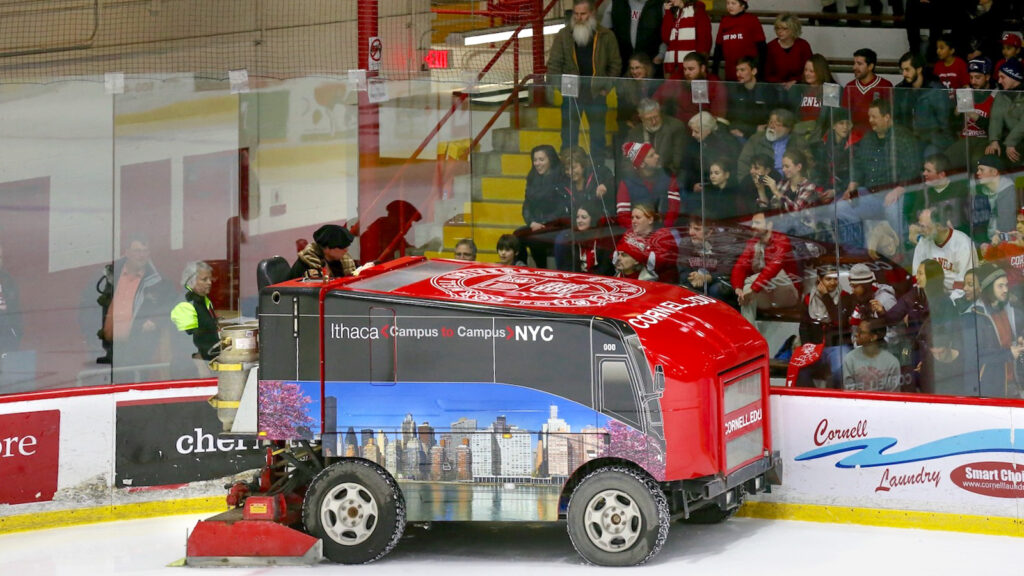 the ice resurfacer at Lynah Rink is pictured with a miniature version of the bus wrap the Campus-to-Campus Bus sports during the University’s sesquicentennial year in 2014–15
