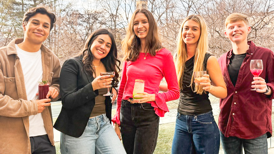 Five students holding their cocktails
