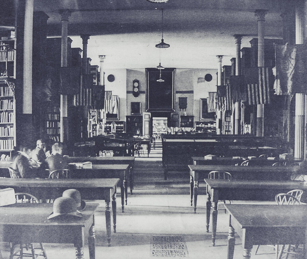 Electric lights are seen in McGraw Hall in 1890 as several students study