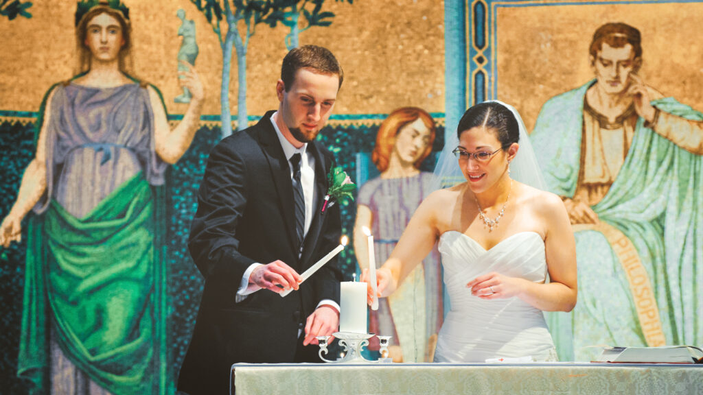 Jennifer D’Amato-Anderson ’07 & Andrew Anderson light candles in Sage Chapel