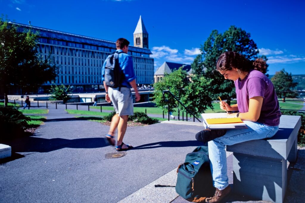 students on the southeast side of the Arts Quad with Olin Library and McGraw Tower in the background, 1990–2000