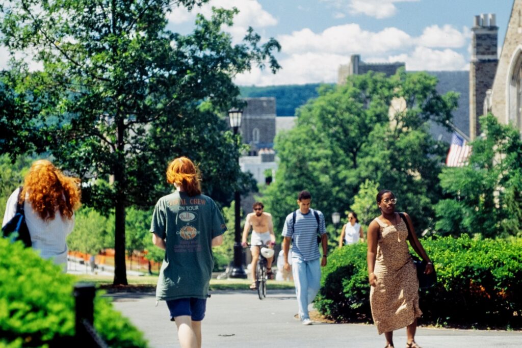 students walk near Willard Straight Hall and the Cornell Store in a vintage color photo from the 1990s