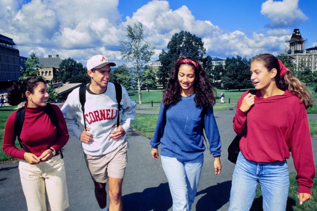 four students walk near the Arts Quad in a vintage color photo from the 1990s