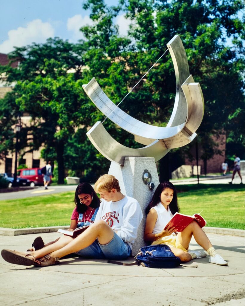 three students sit at the base of the sundial and study in the early 2000s
