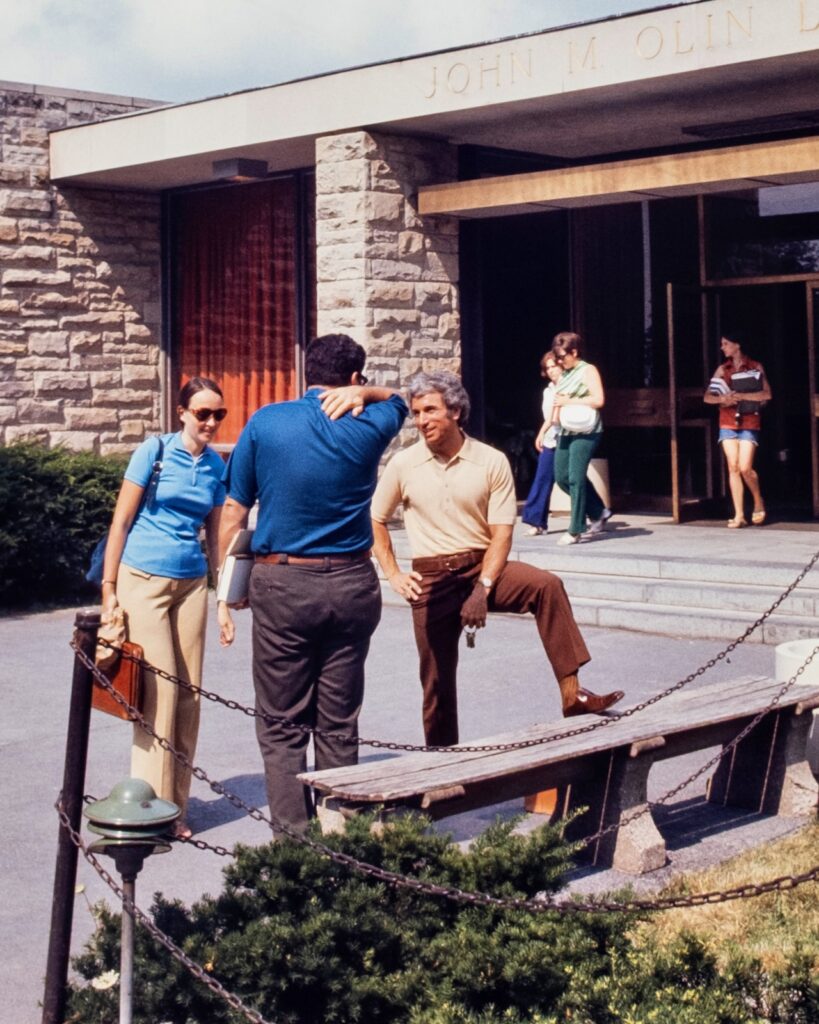several people hang out and chat outside the Olin Library entrance in 1974
