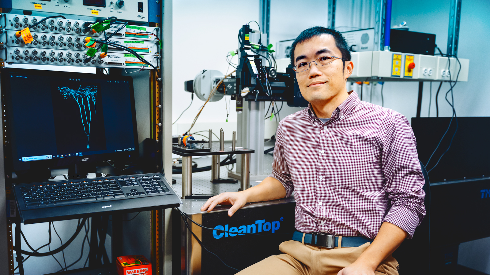 Alex Kwan, Ph.D. ‘09, associate professor in the Meinig School of Biomedical Engineering, with some of his scientific instruments