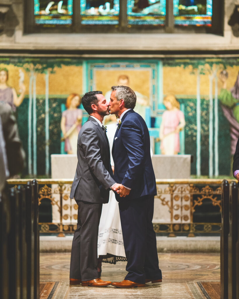 Randy Heffernan ’94, MBA ’10 & Robert Redman kiss in Sage Chapel