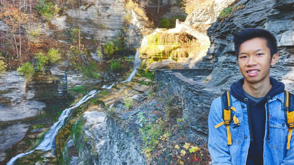 Russell Kwong ’25 posing in front of Lucifer Falls at Treman State Park