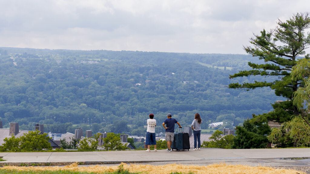A family looks out at the view from the top of the Slope