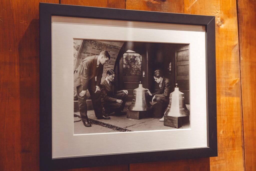 framed, undated black-and-white photo in the Chimes Museum shows several student chimesmasters inspecting bells delivered to the ground floor tower entrance