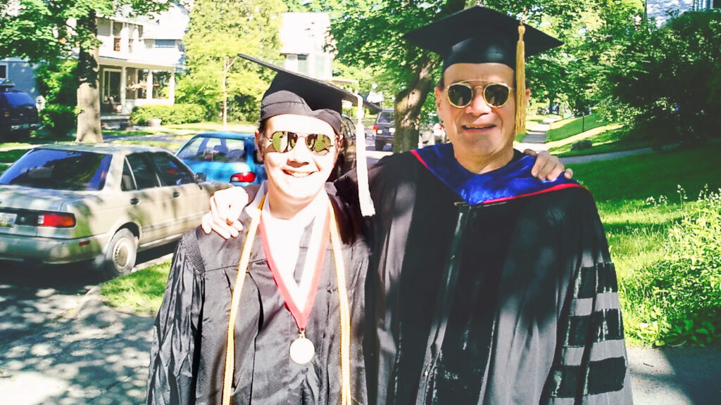 David Rand at Commencement with his father, Prof. Richard Rand, both in academic regalia