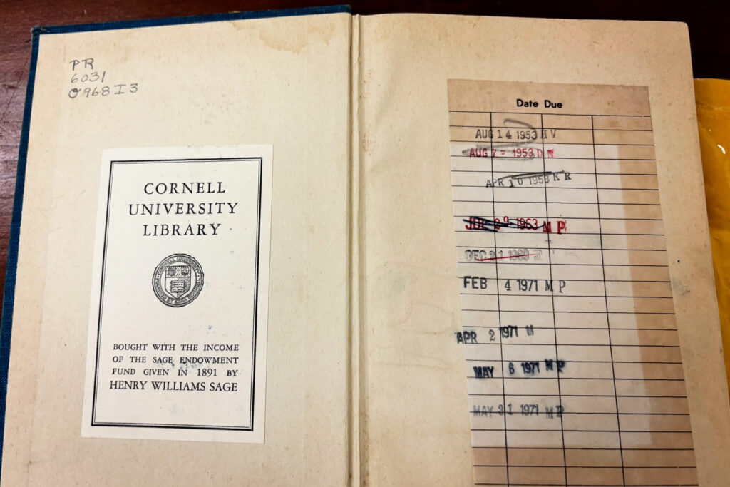 A page open to a Cornell University Library bookplate and a series of old-fashioned stamped due dates
