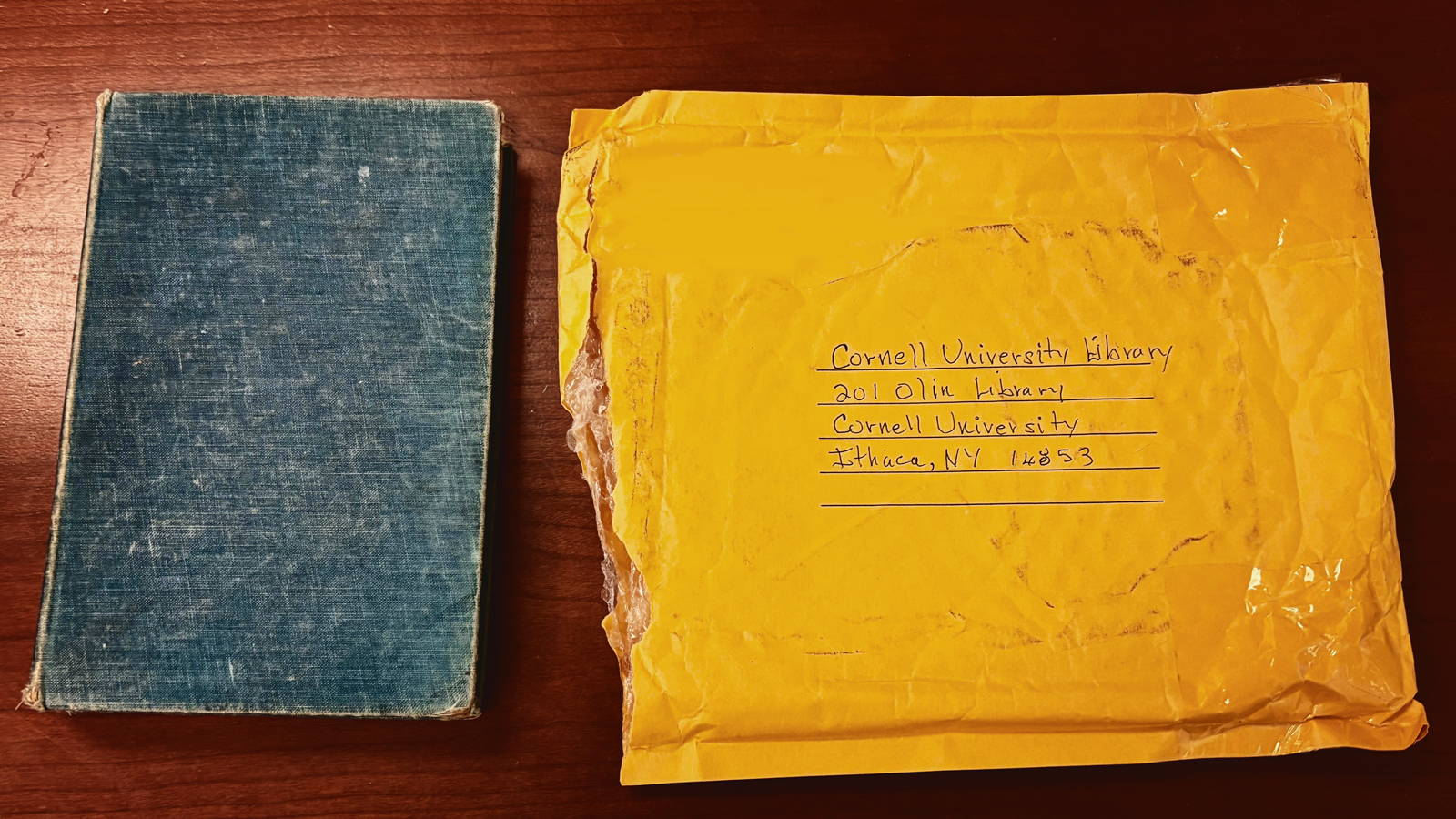 A book and an envelope addressed to Cornell University Library