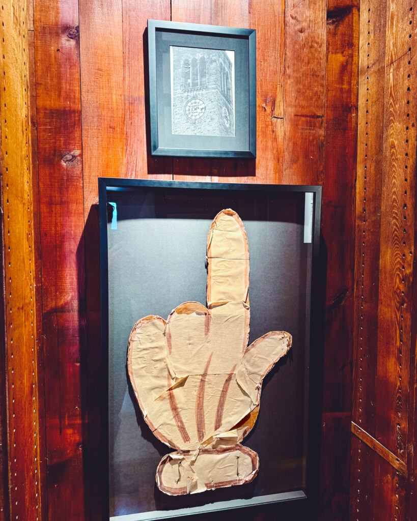 one of the cardboard cartoon hands that was once affixed to a clock tower clock face in 1969 is on display in the Chimes Museum