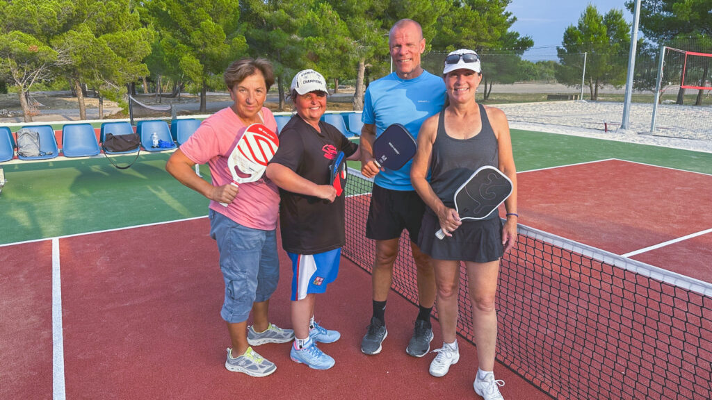 Penny Smith Eifrig and three other people on a pickleball court
