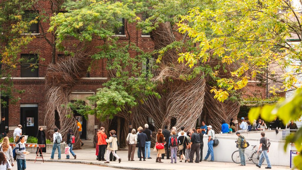 people view an outdoor arboreal art installation created by artist Patrick Dougherty on the Sheldon Court patio in 2006