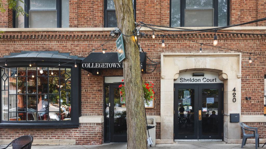 View of the entrance to Sheldon Court in 2026, with the entry to Collegetown Bagels also visible at left