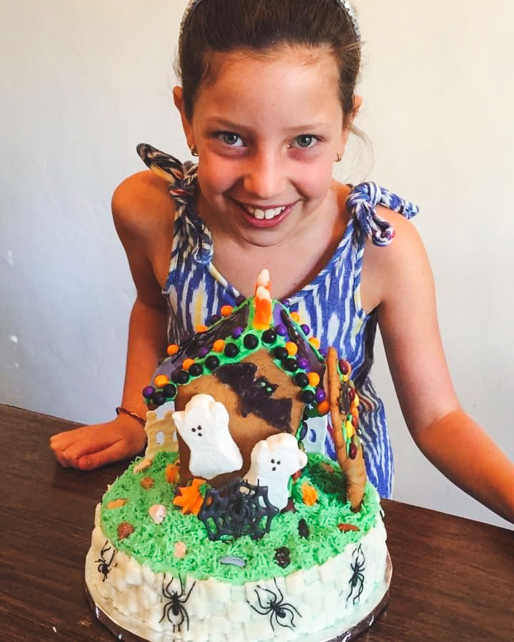 Ivy Woolenberg as a child with a Halloween cake