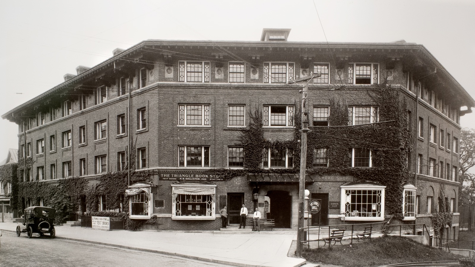 Sheldon Court a few years after its completion in the early 20th century, showing The Triangle Book Store and a smoke shop occupying its ground floor