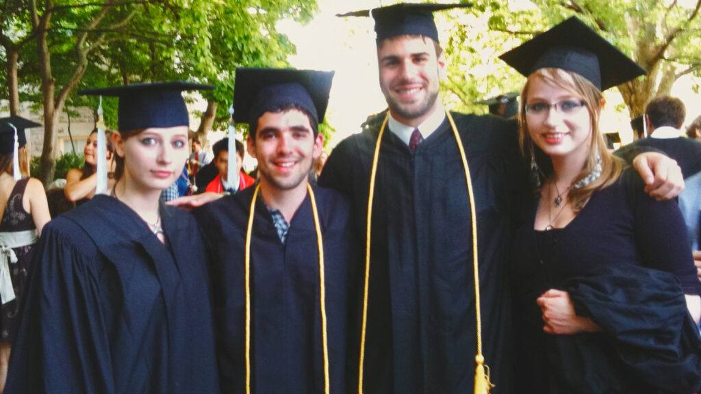 Daniel Anastasio with three friends at commencement in regalia.