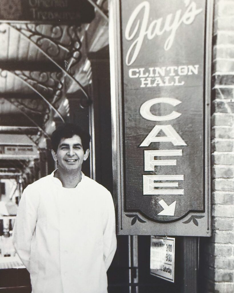 Jay Solomon in front of the sign for Jay's Clinton Hall Cafe