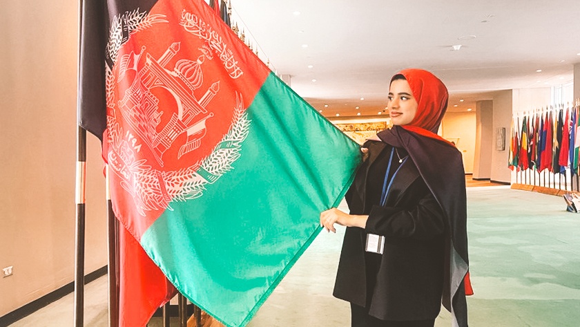 Mursal Rahim holds the flag of Afghanistan at the United Nations.