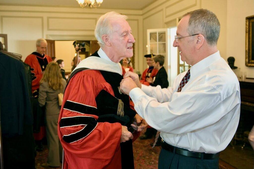 President David Skorton helps former president Frank Rhodes with his robe at as they prepare for Skorton's inauguration in 2006