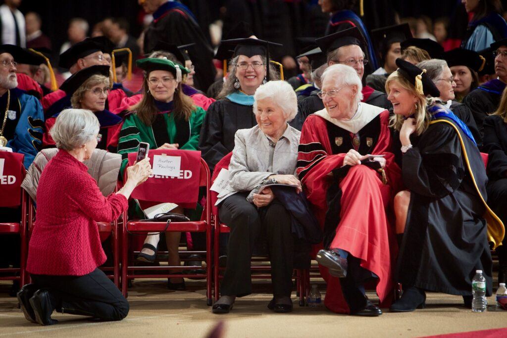Rhodes and wife, Rosa, left, take a photo with Robin Davisson (far right), a faculty member and wife of then-President Skorton, at the 2015 Charter Day celebration