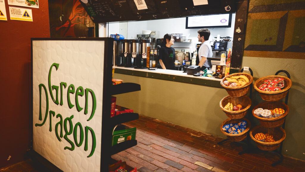student workers at the order counter of the reopened Green Dragon Café in the lower level of Sibley Hall in 2026