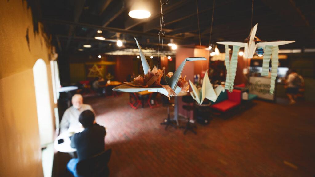 origami creations hang in one corner of the reopened café