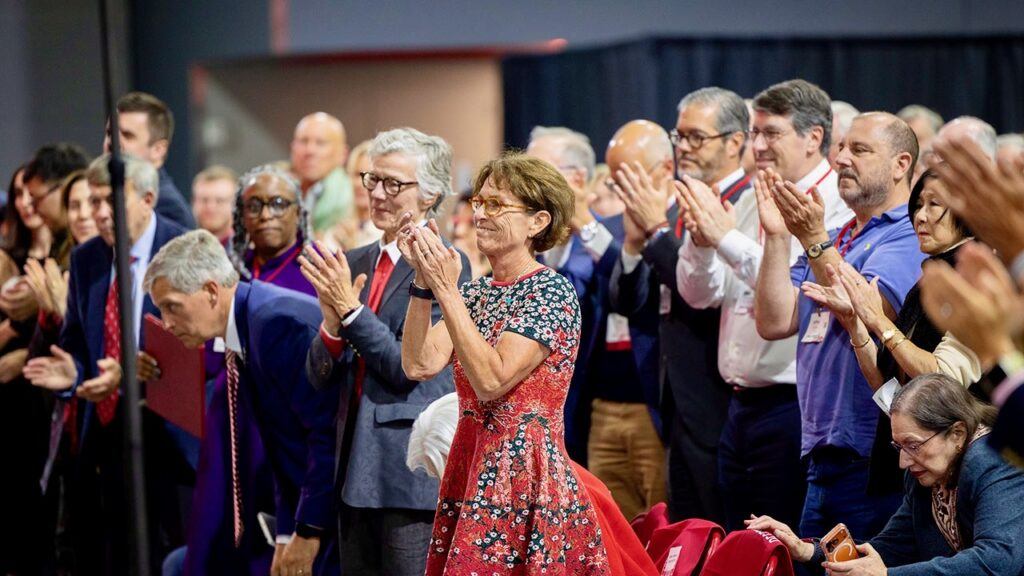 Members of the audience, including Board of Trustees Chair Anne Meinig Smalling ’87, center, applaud following President Michael Kotlikoff's State of the University Address October 15, 2026 in the new Meinig Fieldhouse