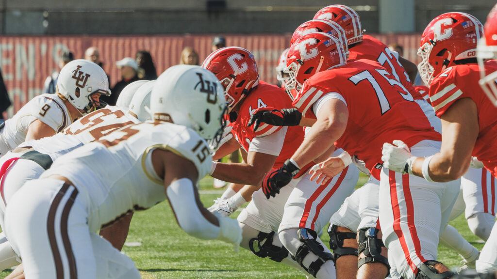 Cornell and Lehigh football players face off across each other on the field during the game.
