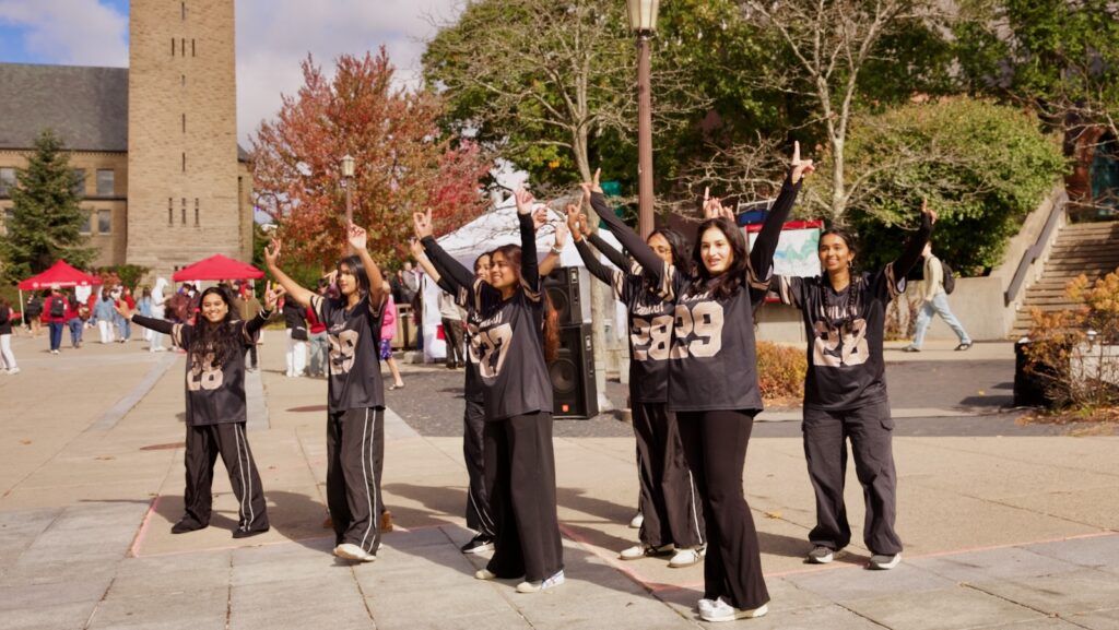 a dance group performs on Ho Plaza as part of the fall festival during Homecoming Weekend