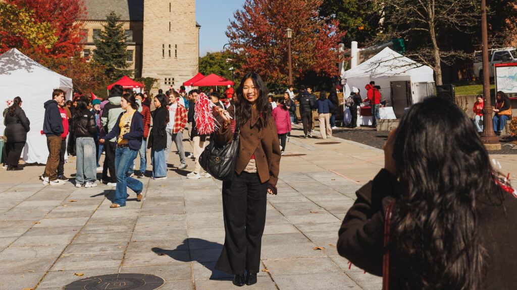 A student poses for a photo on Ho Plaza during Homecoming.