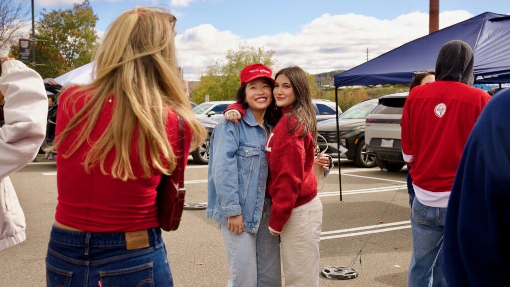 fans pose for photos in the Crescent Lot before the game
